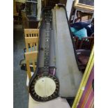 A large vintage cased banjo [room] FOR DETAILS OF ONLINE BIDDING ON THIS LOT CONTACT BAINBRIDGES AND