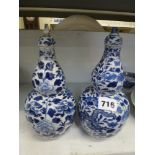 A pair of Chinese blue and white porcelain double-gourd bottle vases, with covers, painted with