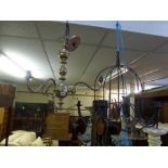 A brass three branch ceiling light and a wrought iron chandelier [room] FOR DETAILS OF ONLINE