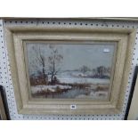 A winter landscape with river and farm buildings by Frank McKelvey, signed, oils (29 x 42 cm),