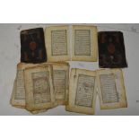 An antique Islamic manuscript book in fragmentary condition, with gilt-bordered panels of text,