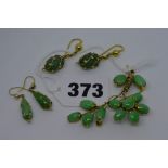 An Eastern green jadeite flower brooch, 14 ct mount, and two pairs of green stone and gold drop