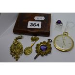 A burrwood cigarette case containing an Ingersoll gilt dress watch, silver-gilt filigree pendant,