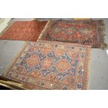 Three old Eastern carpets each with an orange ground and geometric decoration [floor by jewellery