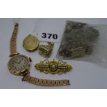 A lady's 9 ct gold wristwatch on gilt bracelet, a part gold locket, a silver-gilt fob seal, a gilt