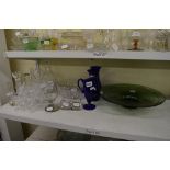 A shelf of glassware including a pair of Bristol blue vases and jug, a cut glass decanter and