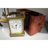A French brass carriage timepiece, circa 1900, with lion trademark, red outer case [W] TO BID ON