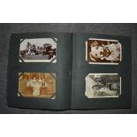 An old postcard album of cards including topographical, dogs and cats, portraits, humour, river