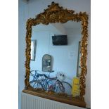 A large gilt framed overmantel mirror with shell and floral decoration TO BID ON THIS LOT AND FOR