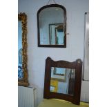 A mahogany dome-topped mahogany mirror and a square oak-framed mirror with ormolu mounted flower