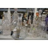 13 good glass decanters and jugs including a pair on a silver plated stand, most with stoppers. [