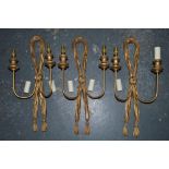 A set of three gilt composition wall lights [under C] TO BID ON THIS LOT AND FOR VIEWING