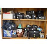 Two shelves of cameras including a Pentax Asahi, a Miranda, a Kodak Duaflex II, an Ensign Double-