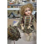 A Kammer & Reinhardt for Simon & Halbig 403 bisque head doll, with blue glass closing eyes, open