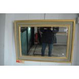 A pretty modern gilt-framed rectangular mirror with bevel glass. TO BID ON THIS LOT AND FOR