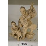 A good Japanese carving of a hunter with boy and falcon, Meiji period, signed, 15 cm [E] TO BID ON