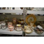 Three shelves of 19th century and later tea and dinner wares including two Rockingham style tea