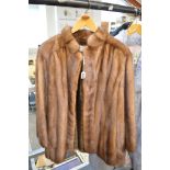 A lady's pastel mink fur jacket with stand-up collar and swing back, hidden hook fastenings [rail