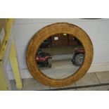 A carved wood circular mirror of leaf and flower design TO BID ON THIS LOT AND FOR VIEWING