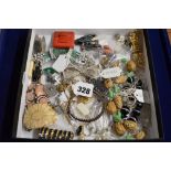 A small carton of good costume jewellery including a large spray brooch in green and white stones,