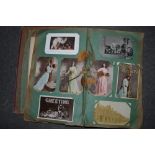 A good early 20th century postcard album including glamour, greetings cards, street scenes, cats,
