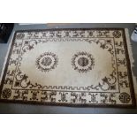 A stylish Chinese rugs with calligraphic decoration in brown and cream [top of stairs] TO BID ON
