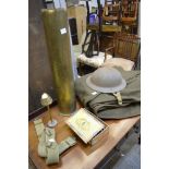 An army grey coat, belt and tin hat, a Trench Art cigarette lighter, a very large brass shell case,