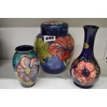 Three items of vintage Moorcroft, comprising: a covered ginger jar decorated with hibiscus, paper