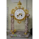 An elaborate French portico mantel clock in pink marble and ormolu, circa 1900, half-hour striking