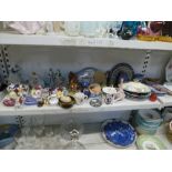 A shelf of mixed china including two Murano glass paperweights, two Continental lace figurines,