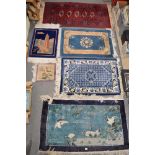 Five small rugs possibly each Chinese decorated with birds, a pagoda and geometric patterns and a