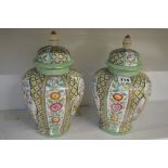 A pair of Continental porcelain covered jars, probably early 20th century Limoges, decorated with