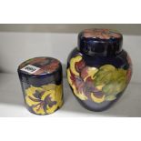 A vintage Moorcroft covered ginger jar decorated with hibiscus on a blue ground, paper label, 6
