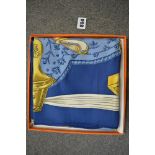 An Hermes silk square in 'Etriers' design in blues and golds, in original box [upstairs shelves]