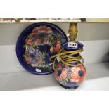 A Moorcroft dish with anemone on a blue ground, script WM in green, 8.5 in, and a table lamp with