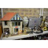 A small wooden doll's house, an Art Deco spelter figurine of a dancer on base, a pottery table lamp,