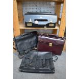 A black leather Masters briefcase with combination lock, a burgundy leather Flaurose briefcase and