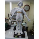 A white figural brass table lamp in the classical style of a lady with her arms outstretched. [s1]