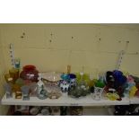 Two shelves of good mainly coloured glassware including Bristol Blue wine glasses, overlaid vases,