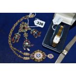 An ornate brooch set with baroque pearls and coloured stones on gilt metal a similar pendant set