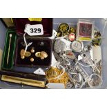 A carton of jewellery in silver including a door key, gold-plated cufflinks and studs, a swizzle