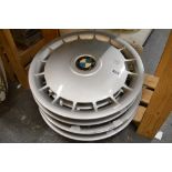 Four BMW hubcaps [bottom pine shelves next to s17] TO BID ON THIS LOT AND FOR VIEWING APPOINTMENTS