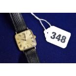 An Omega 1960s man's wristwatch with gilt face and Roman numerals, Hirsch 'crocodile' strap TO BID