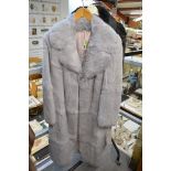 A full length ladies grey coney fur coat and a shorter similar in black [rail top of stairs] TO