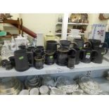 A good collection of mid-19th century pewter tankards and pewter quart jug with side handle, a