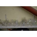 Two shelves of glass ware including wine glasses, decanters, cruet sets, jugs and vases [s84 &