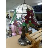 A Tiffany-style table lamp. [pine shelves next to s21] TO BID ON THIS LOT AND FOR VIEWING