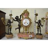 A fine French clock garniture in pink marble, bronze and ormolu, the Vincenti movement half-hour
