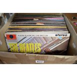 A box of 12 in records, mainly rock and pop from the 1970s, including the Beatles, Kinks, Tubes,