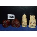 Two signed Japanese netsuke carved as deities and two brown netsuke as a deity and a group of